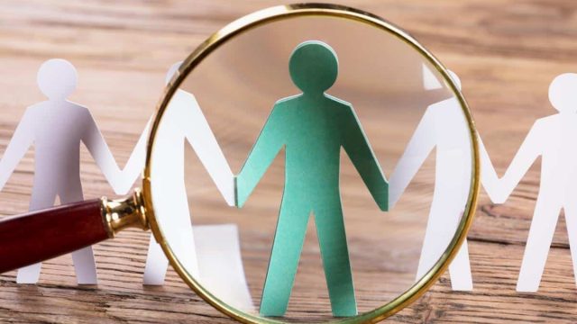 GettyImages 915461616 magnifying glass over a cutout paper figure | موسوعة الشرق الأوسط