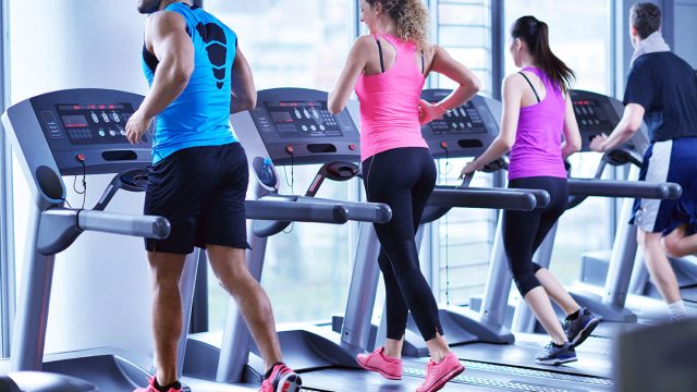 Group walking on treadmillls at gym | موسوعة الشرق الأوسط