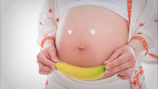 beautiful pregnant woman banana hand what to eat ss | موسوعة الشرق الأوسط