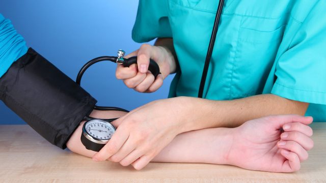 female doctor taking blood pressure | موسوعة الشرق الأوسط