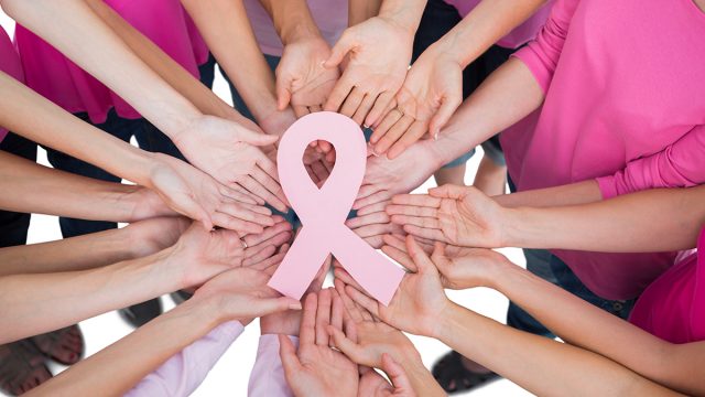 hands holding pink ribbon FB | موسوعة الشرق الأوسط