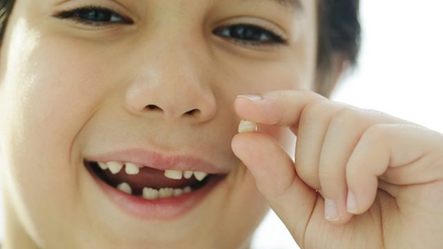 little boy losing his first tooth | موسوعة الشرق الأوسط