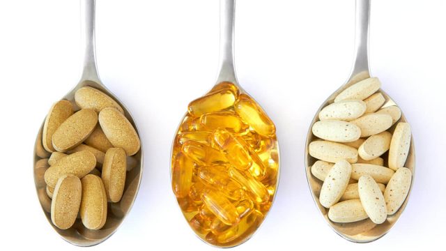 omega 3 capsules on spoons | موسوعة الشرق الأوسط