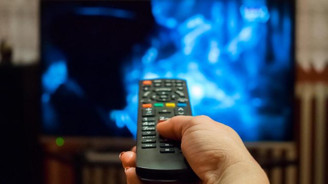 watching tv and using remote control | موسوعة الشرق الأوسط